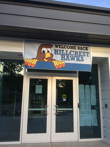 a sign that says Welcome Back Hillcrest Hawks