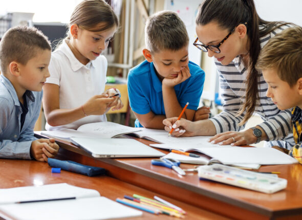 Teacher showing group of students some documents