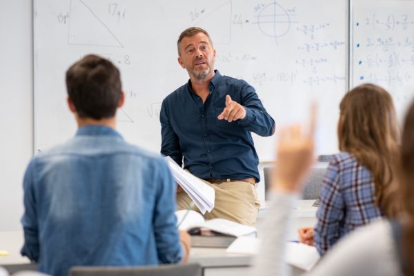 Man teaching high school students