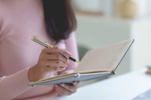 Woman writing in a journal